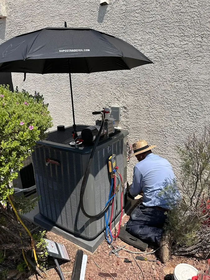 HVAC technician performing outdoor AC maintenance in Catalina